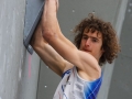 Munich, Germany â August 23: Adam Ondra is seen during the Womens Semi-Finals of the 2014 IFSC Climbing World Championships Bouldering. Bouldering is climbing without the need for ropes or harnesses on typically short, challenging routes. The World Championships are held under the rooftop of the famous Munich Olympic Stadium. Built for the 1972 Olympic Summer Games the architecture was considered revolutionary for its time. The roof, made of large sweeping canopies of acrylic glass stabilized by steel cables should symbolize the Alps.  (Photo Marco Kost / DAV)
