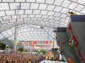 Munich, Germany â August 23: General view of the Womens Semi-Finals of the 2014 IFSC Climbing World Championships Bouldering. Bouldering is climbing without the need for ropes or harnesses on typically short, challenging routes. The World Championships are held under the rooftop of the famous Munich Olympic Stadium. Built for the 1972 Olympic Summer Games the architecture was considered revolutionary for its time. The roof, made of large sweeping canopies of acrylic glass stabilized by steel cables should symbolize the Alps.  (Photo Marco Kost / DAV)