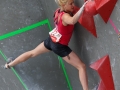 Munich, Germany â August 23: Michaela Tracy (GBR) is seen during the Womens Semi-Finals of the 2014 IFSC Climbing World Championships Bouldering. Bouldering is climbing without the need for ropes or harnesses on typically short, challenging routes. The World Championships are held under the rooftop of the famous Munich Olympic Stadium. Built for the 1972 Olympic Summer Games the architecture was considered revolutionary for its time. The roof, made of large sweeping canopies of acrylic glass stabilized by steel cables should symbolize the Alps.  (Photo Marco Kost / DAV)